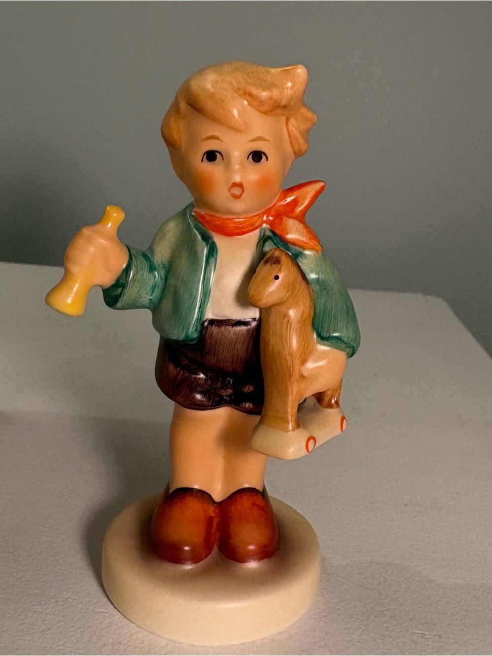 Hummel Goebel Ceramic Boy With a HorsFigurine with teal Jacket and Orange Scarf